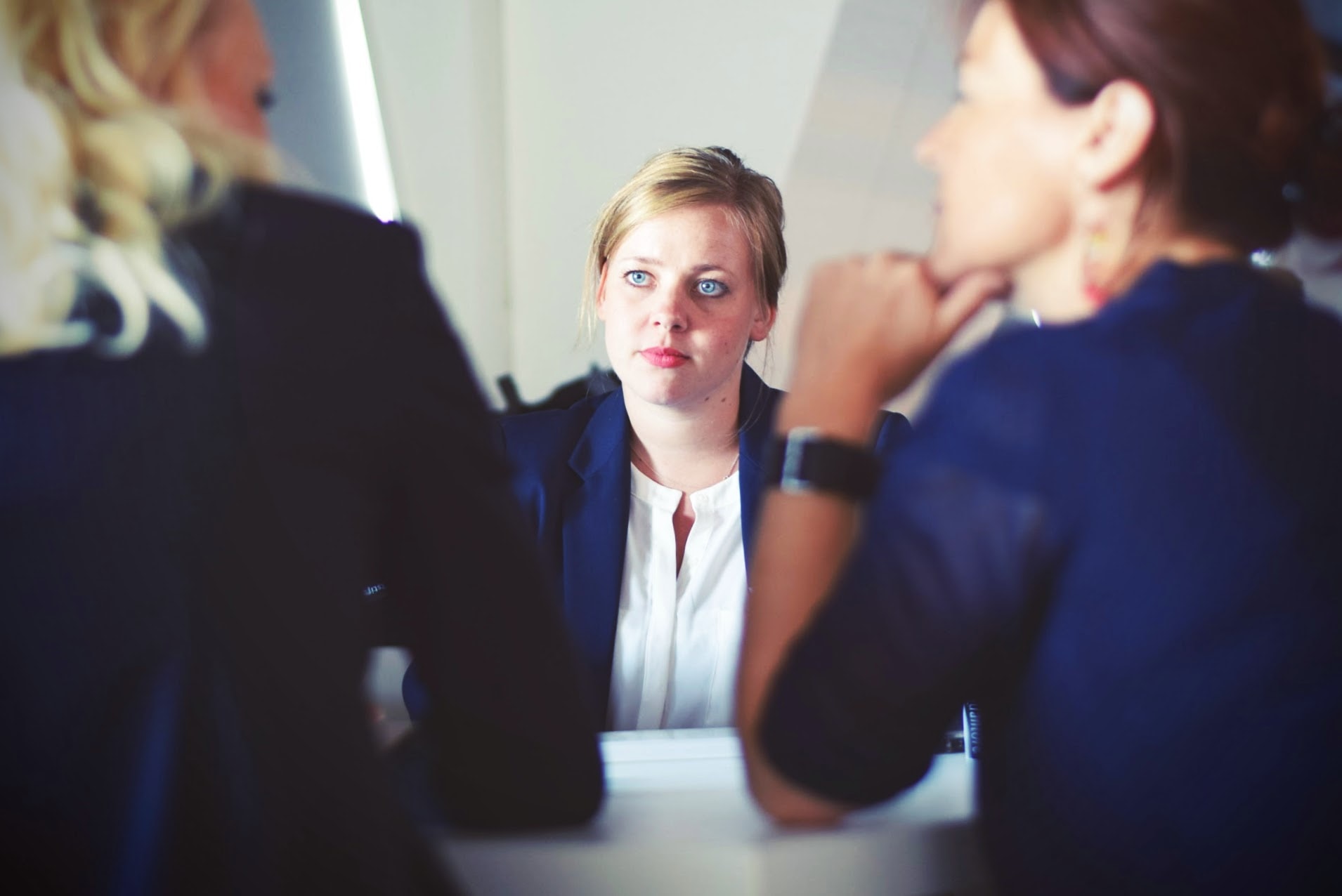 Women sitting at a desk talking