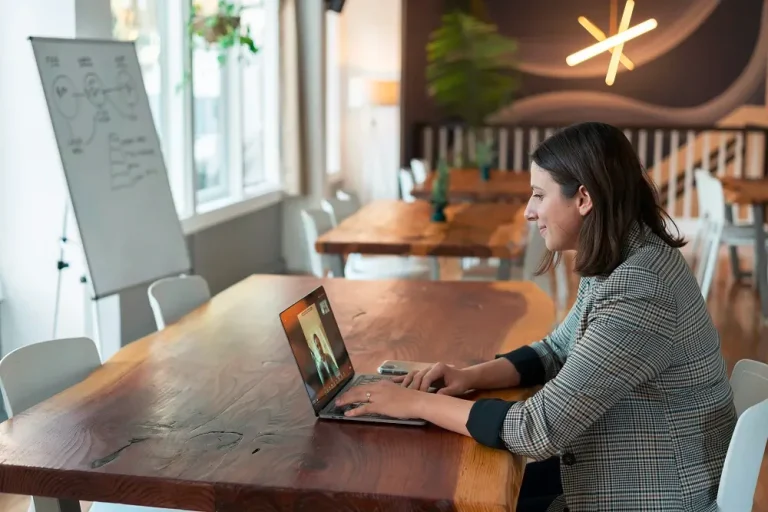 a girl looking at her laptop